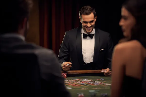 A woman in a luxurious green gown next to an ornate roulette wheel, capturing the upscale casino mood of ILOTBED.