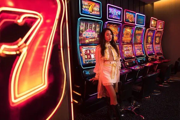 A confident dealer surrounded by casino chips inviting players to access their ILOTBED account, reflecting quick and easy login options.